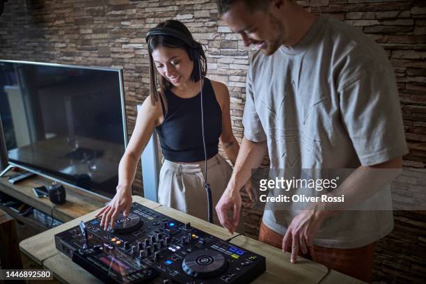 happy young woman and man operating mixing console - lever stock pictures, royalty-free photos & images
