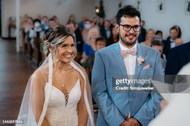 bride and groom at the wedding in the church - married church stock pictures, royalty-free photos & images