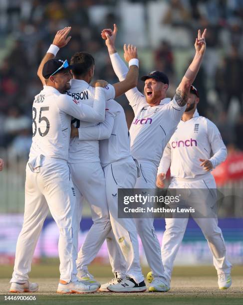 James Anderson of England celebrates with Ben Stokes after taking the wicket of Haris Rauf of Pakistan during day five of the First Test Match...