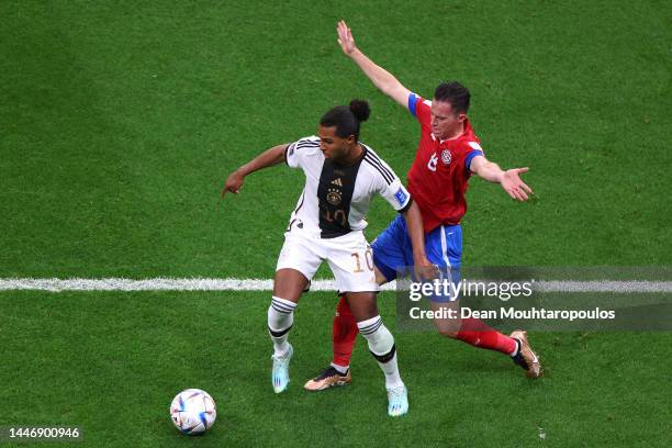 Serge Gnabry of Germany battles for possession with Bryan Oviedo of Costa Rica during the FIFA World Cup Qatar 2022 Group E match between Costa Rica...