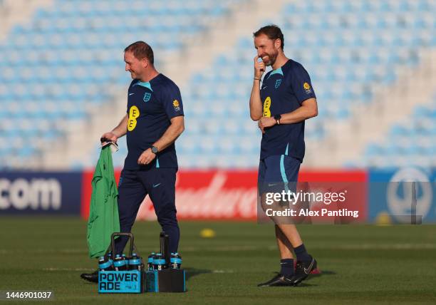 Gareth Southgate, Head Coach of England smiles with Steve Holland during a training sessions on the day after the Round of 16 match against Senegal...