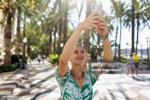 teenage girl sightseeing the wave walkway in alicante - alicante street stock pictures, royalty-free photos & images