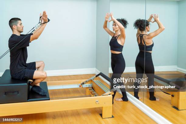 pilates with instructor - reformer stock pictures, royalty-free photos & images