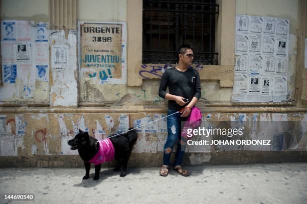 An activist awaits to take part in a march during the celebration of the International Day Against Homophobia and Transphobia in Guatemala City, on...