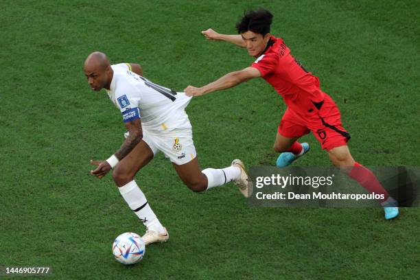 Andre Ayew of Ghana controls the ball against Inbeom Hwang of Korea Republic during the FIFA World Cup Qatar 2022 Group H match between Korea...