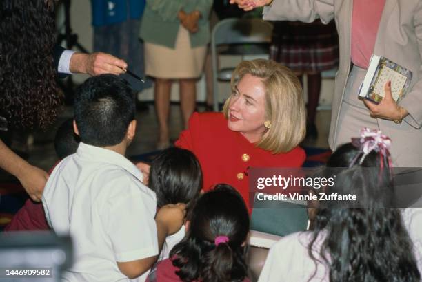 First Lady Hillary Rodham Clinton with the students of Vaughn Next Century Learning Center where she signed copies of her book "It Takes A Village",...