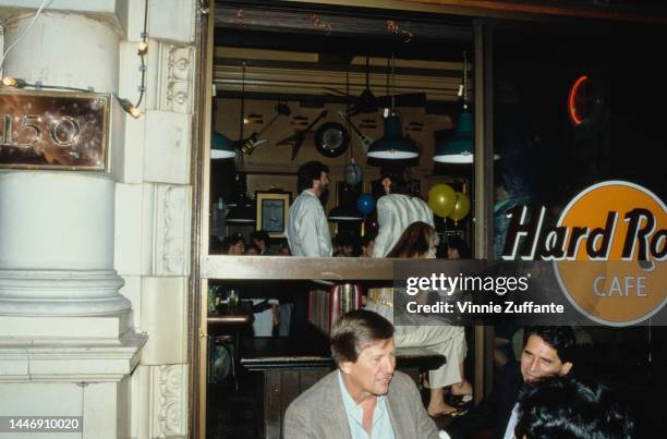 Eric Clapton laughs with Mick Jagger in the Hard Rock Caf� at a party given by Bob Geldof to celebrate his Honorary Knighthood in London, England,...