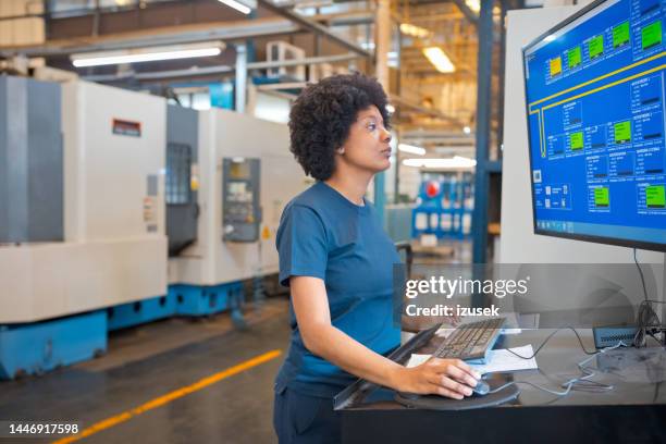 female engineer using computer in factory - cad program stock pictures, royalty-free photos & images