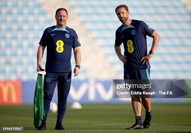 Gareth Southgate, Head Coach of England, and Steve Holland, Assistant Coach of England look on during a training session on the day after the Round...