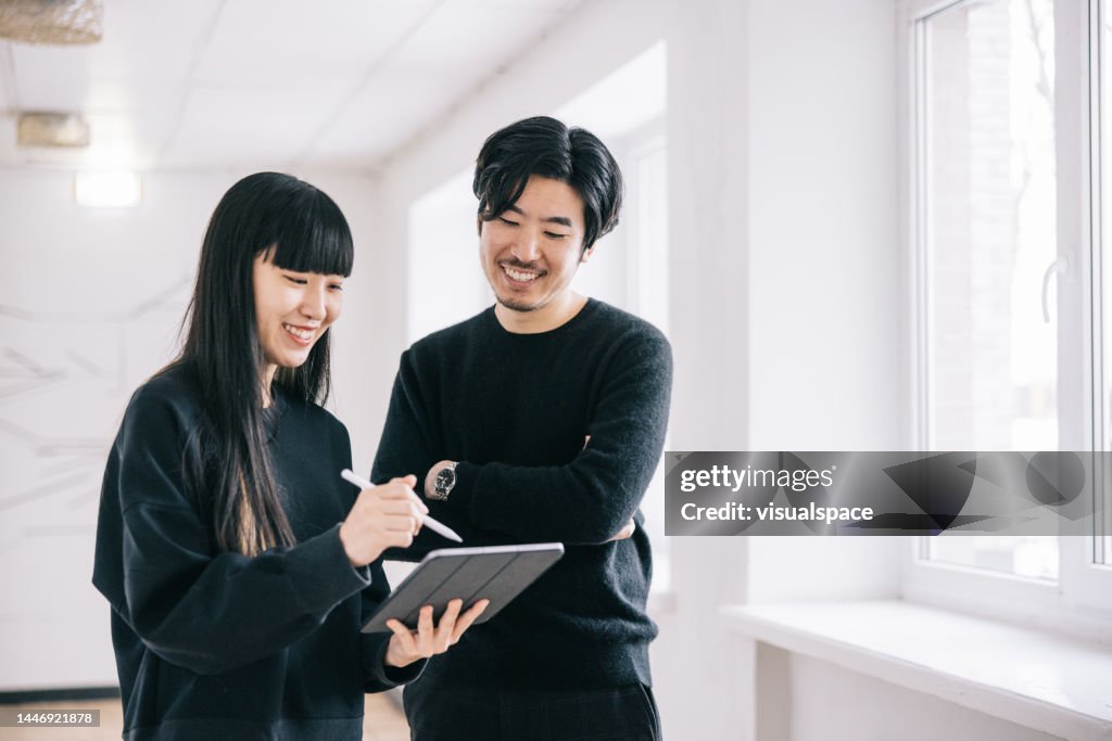 Japanese creative designers at office hallway