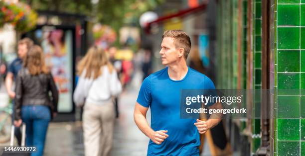 running on the street in london - running man profile stock pictures, royalty-free photos & images