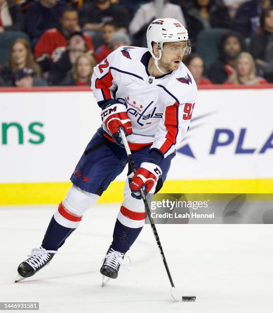 Evgeny Kuznetsov of the Washington Capitals skates the puck down the ice against the Calgary Flames at the Scotiabank Saddledome on December 3 in...
