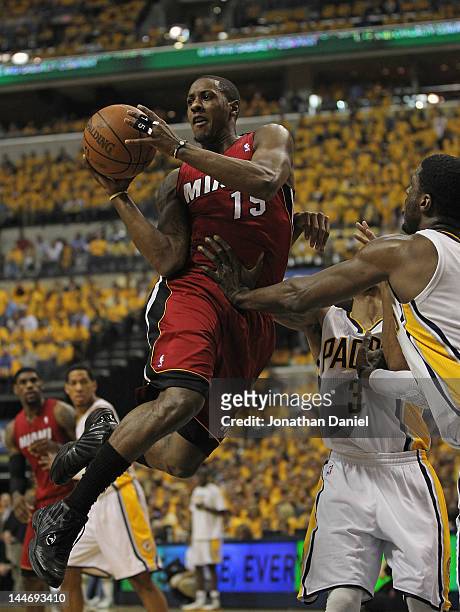 Mario Chalmers of the Miami Heat leaps to pass as George Hill and Ray Hibbert of the Indiana Pacers defend in Game Three of the Eastern Conference...