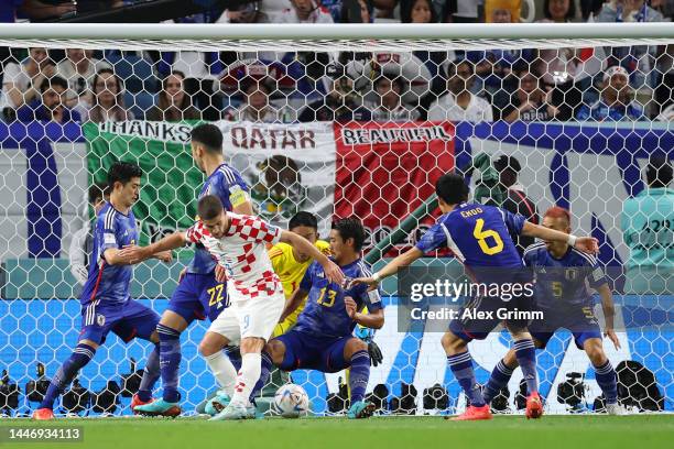 Andrej Kramaric of Croatia controls the ball against the Japan defence during the FIFA World Cup Qatar 2022 Round of 16 match between Japan and...