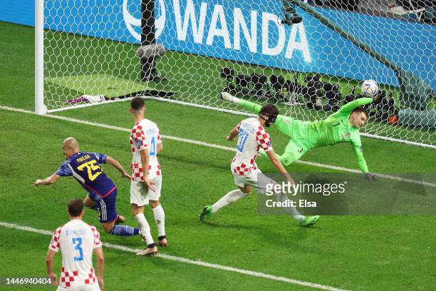 Daizen Maeda of Japan scores the team's first goal past Dominik Livakovic of Croatia during the FIFA World Cup Qatar 2022 Round of 16 match between...