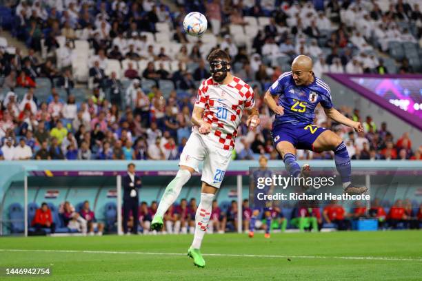 Josko Gvardiol of Croatia jumps for the ball with Daizen Maeda of Japan during the FIFA World Cup Qatar 2022 Round of 16 match between Japan and...