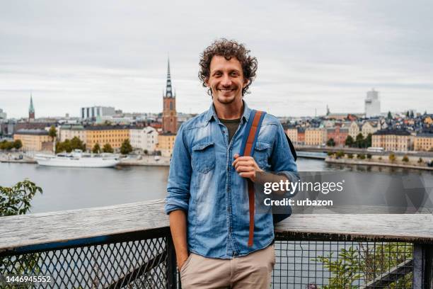 young man at a high viewpoint in stockholm - stockholm old town stock pictures, royalty-free photos & images