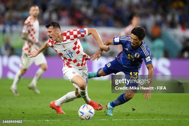 Ante Budimir of Croatia battles for possession with Hidemasa Morita of Japan during the FIFA World Cup Qatar 2022 Round of 16 match between Japan and...