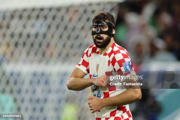 Josko Gvardiol of Croatia wearing a carbon fibre protective face mask reacts during the FIFA World Cup Qatar 2022 Round of 16 match between Japan and...