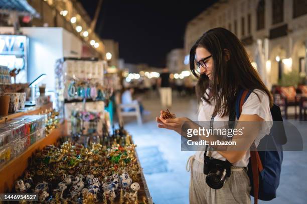 young woman shopping at the street market in qatar - doha street stock pictures, royalty-free photos & images