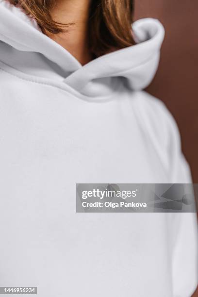 long-haired man dressed in a white hoodie, mockup - camisa con capucha fotografías e imágenes de stock