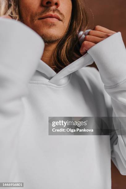 long-haired man dressed in a white hoodie, mockup - long sleeved stockfoto's en -beelden