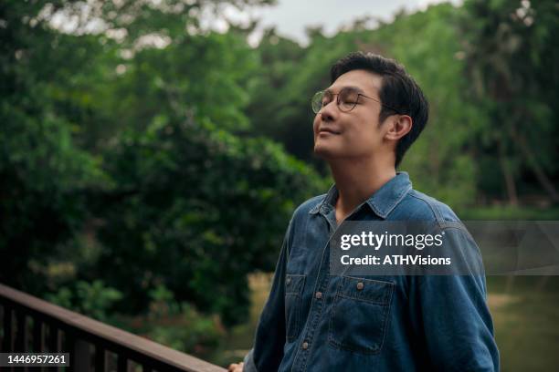 adult man relax and breathing fresh air at park in the weekend - exhaling stock pictures, royalty-free photos & images
