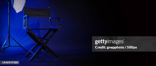 director chair with cinema lightbox sign director text on it and clapperboard megaphone,bangkok,thailand - 映画撮影法 ストックフォトと画像