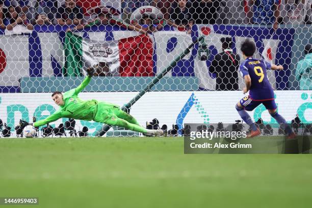 Dominik Livakovic of Croatia saves the second penalty from Kaoru Mitoma of Japan in the penalty shoot out during the FIFA World Cup Qatar 2022 Round...