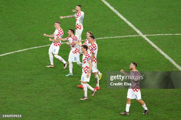 Croatia players react after Dominik Livakovic of Croatia saves a penalty during the FIFA World Cup Qatar 2022 Round of 16 match between Japan and...