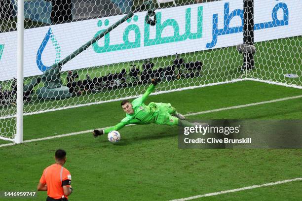 Dominik Livakovic of Croatia saves the second penalty from Kaoru Mitoma of Japan in the penalty shoot out during the FIFA World Cup Qatar 2022 Round...