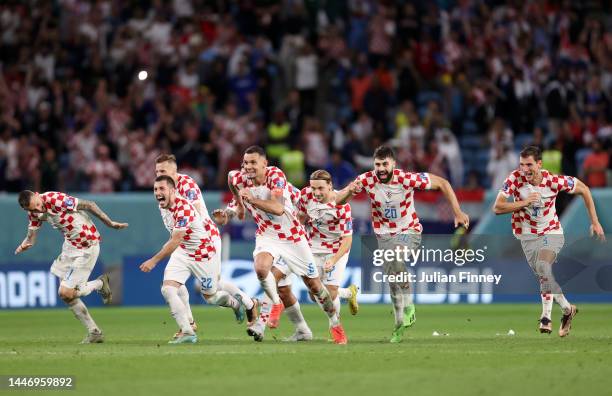 Croatia players celebrate after winning the penalty shoot out during the FIFA World Cup Qatar 2022 Round of 16 match between Japan and Croatia at Al...