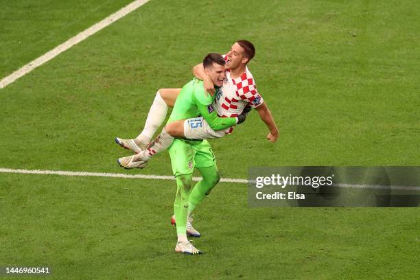 Dominik Livakovic and Mario Pasalic of Croatia celebrate after their side won the penalty shoot out during the FIFA World Cup Qatar 2022 Round of 16...