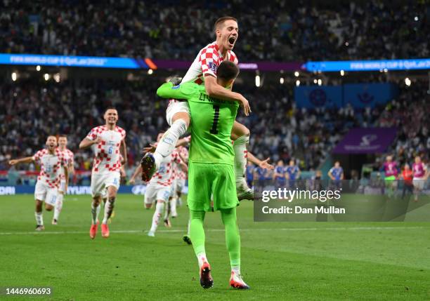 Dominik Livakovic and Mario Pasalic of Croatia celebrate after their side won the penalty shoot out during the FIFA World Cup Qatar 2022 Round of 16...