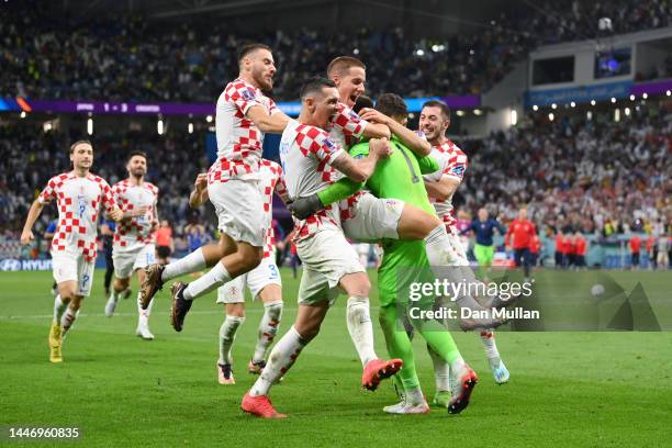 Croatia players celebrate after winning the penalty shoot out during the FIFA World Cup Qatar 2022 Round of 16 match between Japan and Croatia at Al...