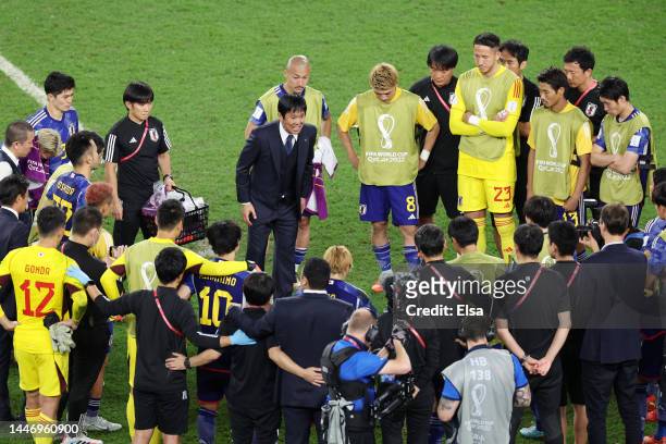 Hajime Moriyasu, Head Coach of Japan, talks to players in the huddle after their defeat through the penalty shootout during the FIFA World Cup Qatar...