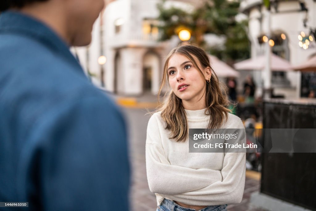 Young couple having an argument outdoors