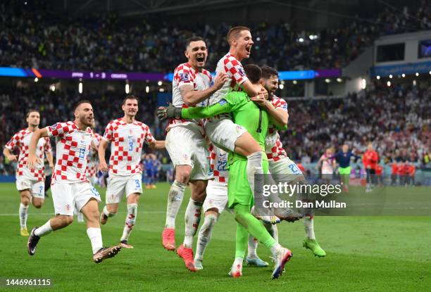 Croatia players celebrate after winning the penalty shoot out during the FIFA World Cup Qatar 2022 Round of 16 match between Japan and Croatia at Al...