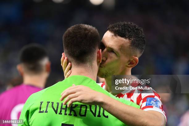 Dominik Livakovic of Croatia is congratulated by Ivan Perisic after their victory through the penalty shootout in the FIFA World Cup Qatar 2022 Round...