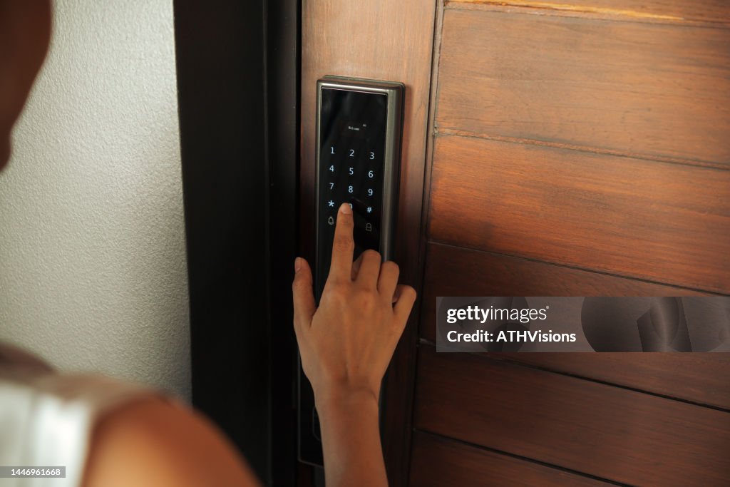 Close-up Woman hand Pressing down on electronic access control at door house