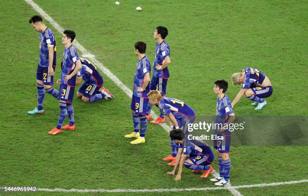 Japan players react after losing the penalty shoot out during the FIFA World Cup Qatar 2022 Round of 16 match between Japan and Croatia at Al Janoub...