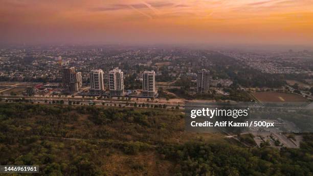 high angle view of buildings against sky during sunset,islamabad,pakistan - islamabad foto e immagini stock