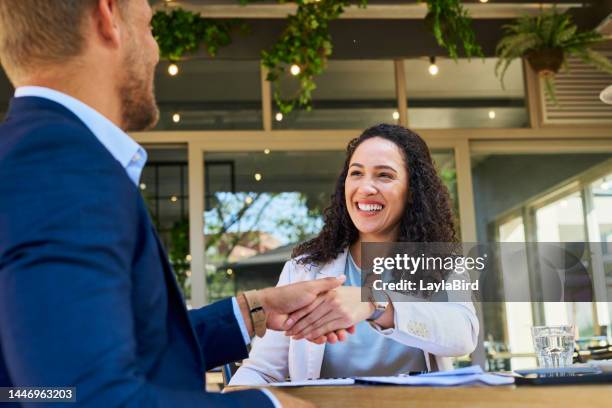 hotel receptionist, guest and welcome hand shake to travel businessman in qatar lobby for concierge accommodation. thank you handshake, hospitality industry or b2c woman greeting man by shaking hands - hand check bildbanksfoton och bilder