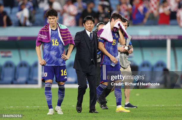 Takehiro Tomiyasu and Hajime Moriyasu, Head Coach of Japan, react after their side lost the penalty shoot out during the FIFA World Cup Qatar 2022...