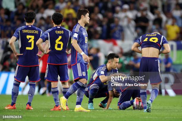 Japan players react after losing the penalty shoot out during the FIFA World Cup Qatar 2022 Round of 16 match between Japan and Croatia at Al Janoub...