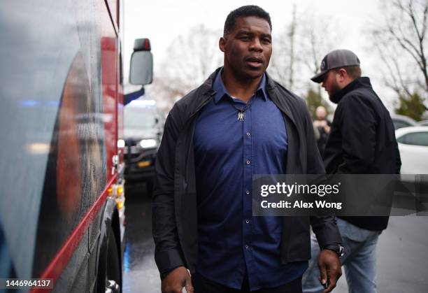 Georgia Republican senate candidate Herschel Walker speaks to members of the press after a campaign stop on December 5, 2022 in Dawsonville, Georgia....