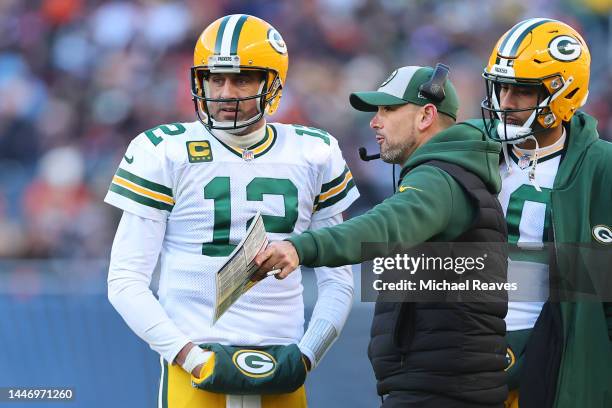 Aaron Rodgers of the Green Bay Packers talks with head coach Matt LaFleur against the Chicago Bears at Soldier Field on December 04, 2022 in Chicago,...