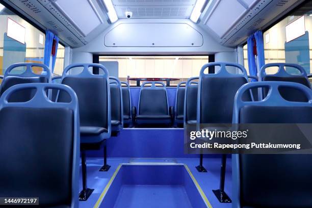 interior of modern bus with passenger seats - bus seat foto e immagini stock