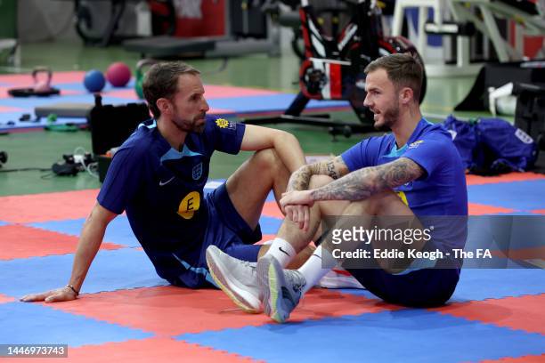 Gareth Southgate, Head Coach of England, talks to James Maddison of England during a training session on the day after the Round of 16 match against...
