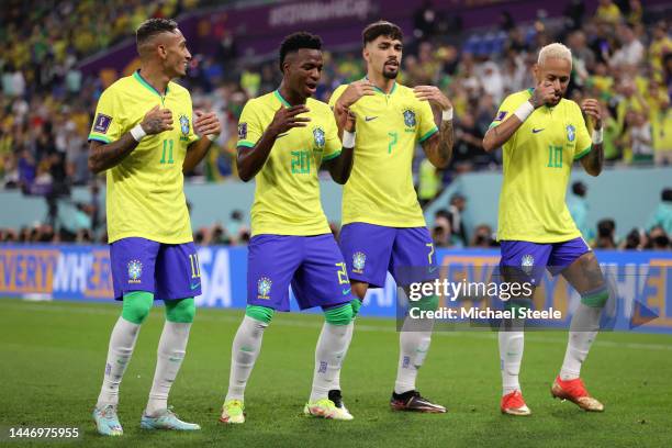 Vinicius Junior of Brazil celebrates with teammates after scoring the team's first goal during the FIFA World Cup Qatar 2022 Round of 16 match...